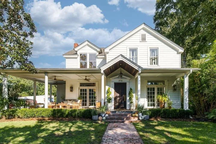 Renovated white home with a wraparound porch at 274 Grove Street, Charleston